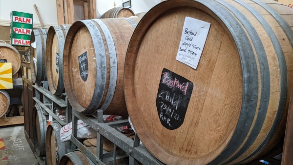 Barrels containing craft beer in a row. Photo taken at Craftwork Brewery in Oamaru, New Zealand.