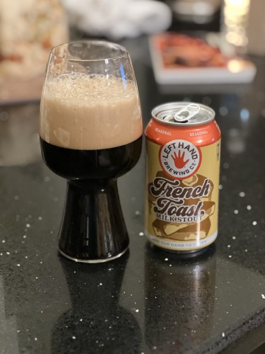 A can of Left Hand brewing French Toast milk stout. The iconic red left handprint logo and a band of red top the can, while buttery yellow and brown highlights illustrate a slice of French toast smothered in syrup.
