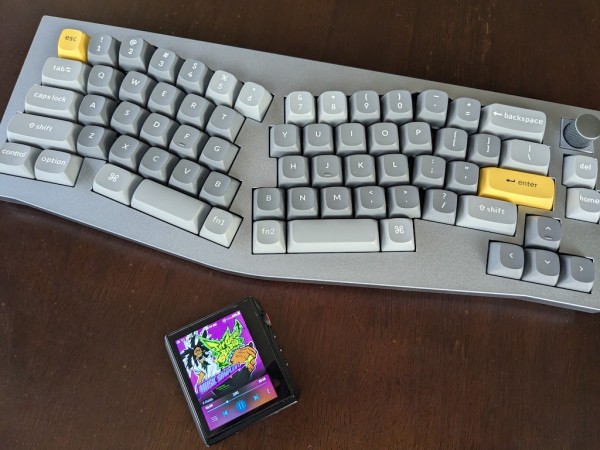 A computer keyboard and an mp3 player. The Jet Set Radio soundtrack's album cover is showing on the mp3 player screen.
