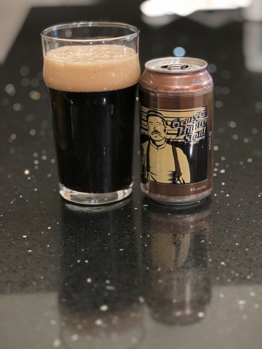 George Hunter stout in a brown 12 ounce can with a tan and black image of a man in suspenders and a north shore cap. A pint glass of beer is to the left with a creamy head.