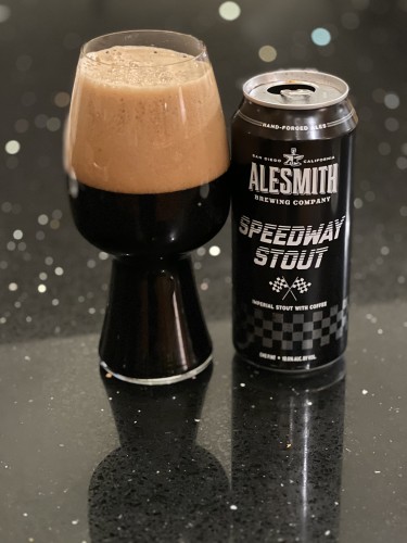 A stout glass 2/3 full of beer and 1/3 tan head. The can is jet black with silencer lettering and a crossed set of checkered-flags.