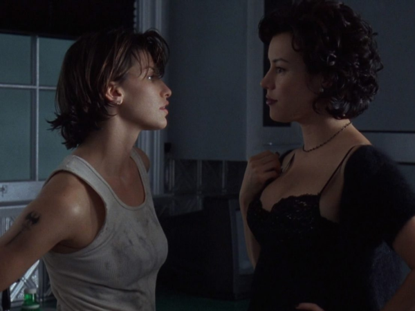 Two women in a kitchen facing each other.

One, in a dirty top and a labris tattoo on her arm, the other in a lacy black nightie and a shrug.
